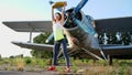 at sunset, athletic, young woman in sunglasses, in tights, doing exercises with weight, heavy weight plate, on an Royalty Free Stock Photo