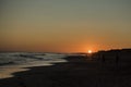 Sunset at atlantic ocean beach with windy land at the end of beautiful day Royalty Free Stock Photo