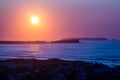 Sunset in the Atlantic Ocean over the Peniche isthmus, the island of Berlenga and the dunes of portuguese west coast