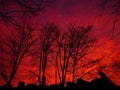 Red terrible terrible sky and a contour of houses