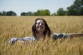 Sunset and atmospheric mood. girl enjoy with sunshine in wheat field. woman feel joy and relax in wheat field. girl in rye at