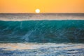 Sunset background, big surfing ocean wave front view, tropical s