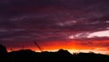The sunset on the background of production,on the mountains and a cargo crane,industrial sunset. Royalty Free Stock Photo