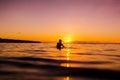 Sunset in Bali and surfer waiting for wave Royalty Free Stock Photo