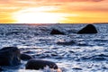 Sunset at Baltic sea stone shore, in Estonia, Viimsi. View over Baltic sea with stones to beautiful sunset at horizon Royalty Free Stock Photo