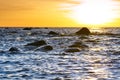 Sunset at Baltic sea stone shore, in Estonia, Viimsi. View over Baltic sea with stones to beautiful sunset at horizon Royalty Free Stock Photo