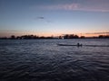 Sunset on the banks of the Atrato River, the silhouette of a man in a boat Royalty Free Stock Photo