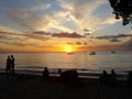 Sunset in Barbados with the silhouette of people enjoying drinks on the beach Royalty Free Stock Photo