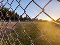 sunset baseball field chain link fence closeup afternoon sports ballpark park sport fields athletics fencing Royalty Free Stock Photo