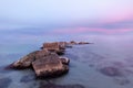 Sunset on the beach of Aguamarga, Alicante. Pastel colors of a sunset on the beach with sea rocks of protagonists in the