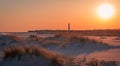 Sunset at the beach as Cape May Lighthouse stands in the background at southernmost tip of NJ Royalty Free Stock Photo