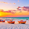 Sunset on the beach with boats in the sea and seagulls flying overhead Royalty Free Stock Photo