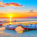 Sunset on the beach with boats in the sea and seagulls flying overhead Royalty Free Stock Photo