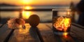 sunset beach cafe glass of orange water with ice and seashell on wooden table on sunset beach at sea beautiful summer seascape Royalty Free Stock Photo