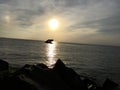 Sunset Beach, Cape May New Jersey just before Sunset, rocks in foreground, sunken concrete ship Atlantus on horizon Royalty Free Stock Photo