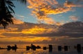 Sunset, beach chairs, palm trees, infinity swimming pool silhouette. Maldives Royalty Free Stock Photo