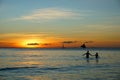 The sunset in the beach with the couple holding hands