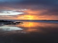 Sunset at the beach with intense glowing orange, yellow, red col