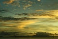 Sunset at the beach by the pier on a cloudy romantic day