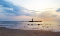 Sunset on the beach with light house on the rock island Royalty Free Stock Photo