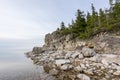 Sunset on the beach. Limestone cliff in the sea under blue sky and white clouds Royalty Free Stock Photo