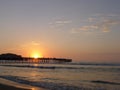 Sunset in a beach with an old pier, south of Lima Royalty Free Stock Photo