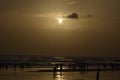 Sunset at beach with people playing in water Royalty Free Stock Photo