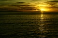 Sunset at the beach by the pier on a cloudy romantic day