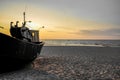 Sunset on the beach on the Polish Baltic Sea. Fishing boat in the evening