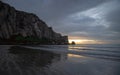 Sunset beach reflections at Morro Rock on the central coast of California at Morro Bay California USA Royalty Free Stock Photo