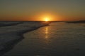 sunset on the beach. Reflections on the sea and the coast. Royalty Free Stock Photo