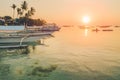 Sunset on the beach with silhouette of banca boat at Panglao Island, Bohol, Philippines