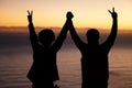 Sunset, beach and silhouette of couple celebration, success or winning and holding hands in shadow, night or dark. Sky Royalty Free Stock Photo