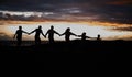 Sunset, beach and silhouette of family with children by ocean for bonding, quality time and peace. Shadow, nature and Royalty Free Stock Photo