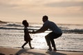 Sunset, beach and silhouette of father with girl child in nature, bond and playing, freedom and enjoying summer vacation