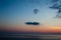 Sunset at the beach with some clouds in the sky. Blue and pink shades with dark clouds. Quiet place. Relaxing scene of beaches. Be Royalty Free Stock Photo