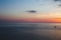 Sunset at the beach with some clouds in the sky. Blue and pink shades with dark clouds. Quiet place. Relaxing scene of beaches. Be Royalty Free Stock Photo