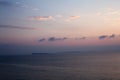 Sunset at the beach with some clouds in the sky. Blue and pink shades with dark clouds. Quiet place. Relaxing scene of beaches. Be Royalty Free Stock Photo