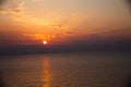 Sunset at the beach with some clouds in the sky. Blue and pink shades with dark clouds. Quiet place. Relaxing scene of beaches. Be Royalty Free Stock Photo