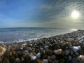 Sunset on the beach of stones. Royalty Free Stock Photo