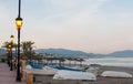 Sunset beach view with lanterns, boats and mountains Royalty Free Stock Photo