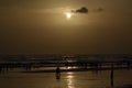 Sunset at beach where people walking on sand and playing Royalty Free Stock Photo