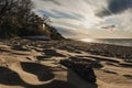 Sunset at the beach with wood in the forground and the ocean in the background