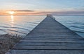 Sunset beach with wooden boardwalk, dreamy romantic scenery Royalty Free Stock Photo