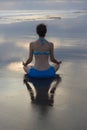 Sunset beach yoga practice in Bali. Lotus pose. Padmasana. Hands in gyan mudra. Meditation and concentration. Zen life. Relaxation Royalty Free Stock Photo