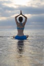 Sunset beach yoga practice in Bali. Lotus pose. Padmasana. Hands in namaste mudra. Meditation and concentration. Zen life. Yoga Royalty Free Stock Photo