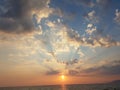 sunset beams clouds sun blue and orange golden colors greece