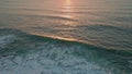 Sunset beams reflecting sea water drone view. Wonderful ocean waves splashing Royalty Free Stock Photo