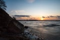 Sunset at a natural beach with split rock in the forground and the ocean in the background