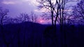 Sunset with beautiful purple colour sky behind the hill and image is taken in forest Royalty Free Stock Photo